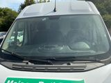 a white van with a green sign on the front of it