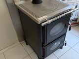a stove that is sitting in the corner of a room