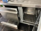 stainless steel counter top with open oven door in kitchen