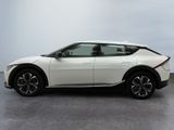 the white car is parked on the concrete floor in the room