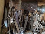 a box full of silver spoons and spoons in it