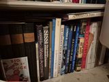 many books that are on a shelf in a room