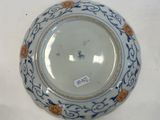 a white plate with a blue and orange design on it