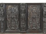 a large wooden panel with carvings on it