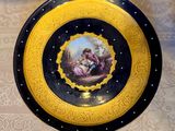 a plate with a painting on it sitting on a table