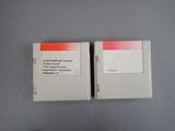 two nintendo game cartridges sitting on top of each other on a table