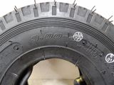 a close up of a tire on a white surface