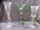 three glass vases that are sitting on a table