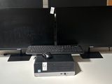 two computer monitors and a keyboard on a desk