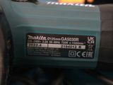 a close up of a corded drill on a table