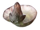 a glass bowl with a bird on it on a white surface