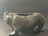 an image of a metal object on a table with a gray background
