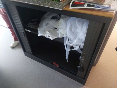 a black cabinet with a bunch of items in it