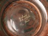 a close up of a brown vase with writing on it