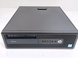 the hp desktop computer is sitting on a white surface