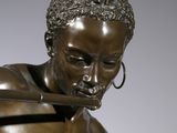 bronze statue of a man with a sword in his hand