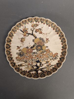 an image of a decorative plate with a bird and flowers on it