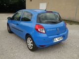 a small blue car parked in a parking lot