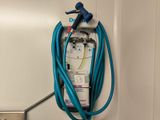 a blue hose attached to a wall mounted power strip