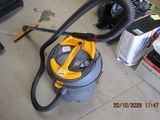 a vacuum that is sitting on the floor next to other items
