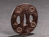a small brown piece of metal with flowers on it