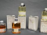 several bottles of perfume are lined up on a gray surface