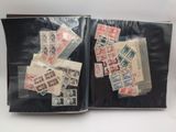 an open book with stamps on it sitting on top of a table