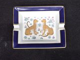 a blue and white plate with a picture of two cats on it