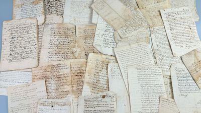 a pile of old papers sitting on a table