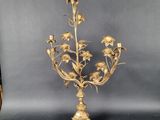 brass candelabra with flowers and leaves on a stand