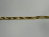 a close up of a gold bracelet on a white surface