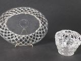 a glass bowl and a glass candle holder on a table