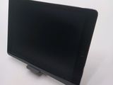 a tablet that is sitting on a stand on a table