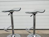 pair of chrome bar stools with glass top and chrome base