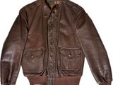 the jacket is made of brown leather and has a zippered collar