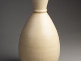 a white vase that is sitting on a table