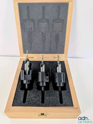 a set of four drill bit set in a wooden case