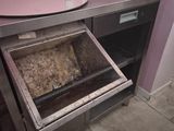 an open oven with meat inside of it in a kitchen