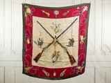 a picture of a wall hanging with two guns and a scarf