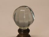 une petite boule de verre posée sur un socle en bois