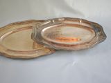 pair of glass serving dishes with gold rims on a white surface