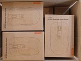 several boxes of computer mouses are stacked on top of each other