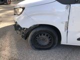a white van that has been damaged and is sitting on the side of the road