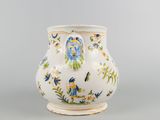 a white vase with blue and orange flowers on it