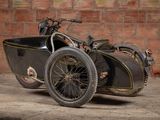 a motorcycle with a side car parked in front of a brick wall