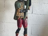 a statue of a man holding a flower in his hand