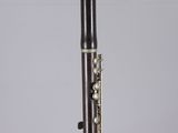 a close up of a clarinet on a clear surface with a white background