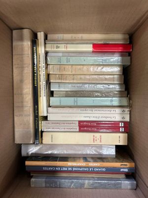 a box full of books that are stacked on top of each other