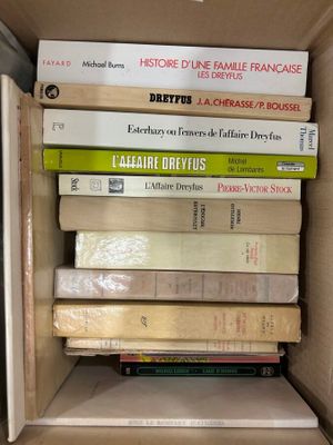 many books stacked on top of each other in a box