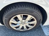 a close up of a tire on a white car